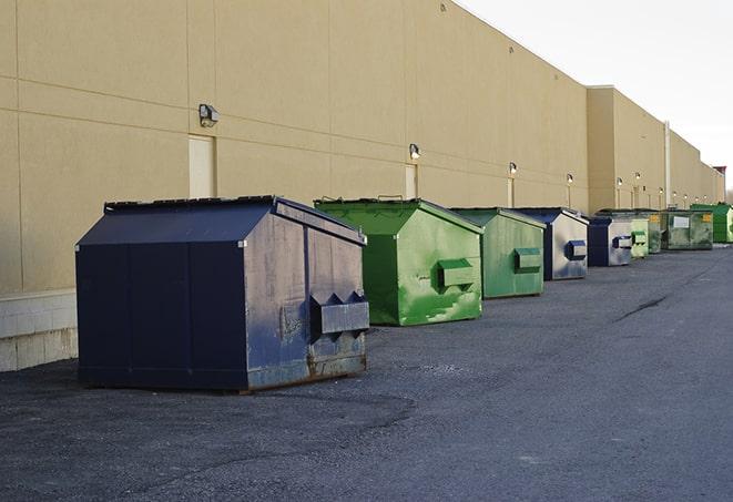 a construction worker moves construction materials near a dumpster in Dallas